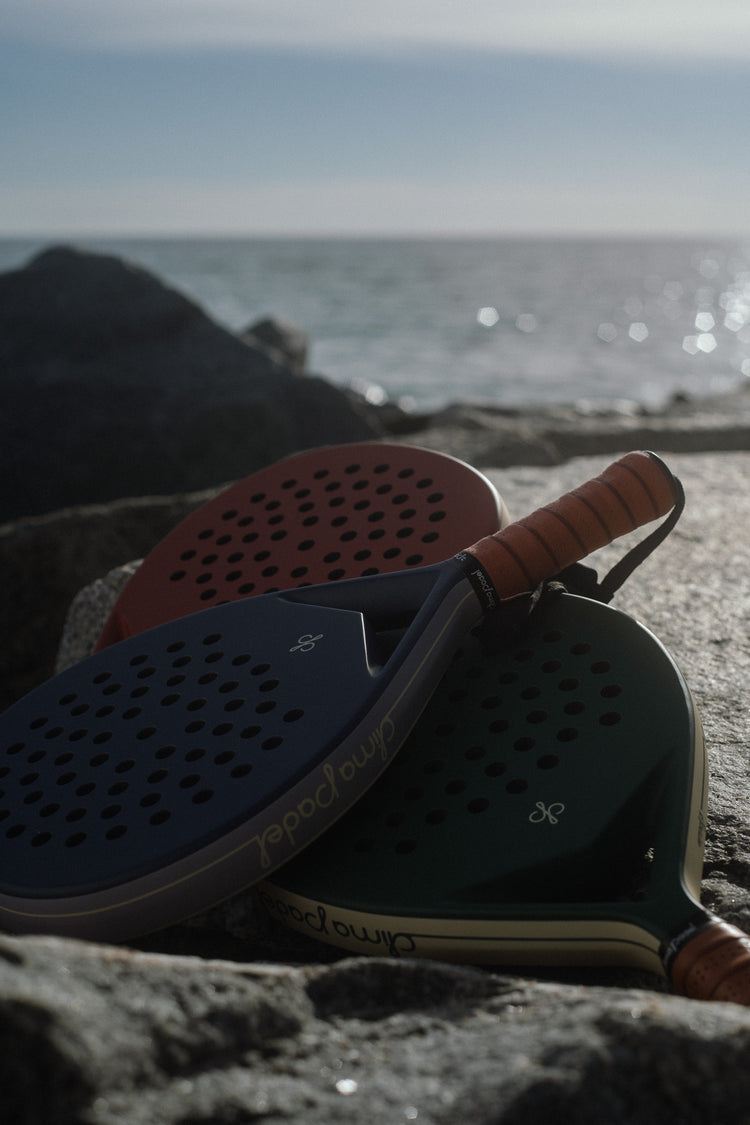 Clima rackets resting on the rocks by the sea